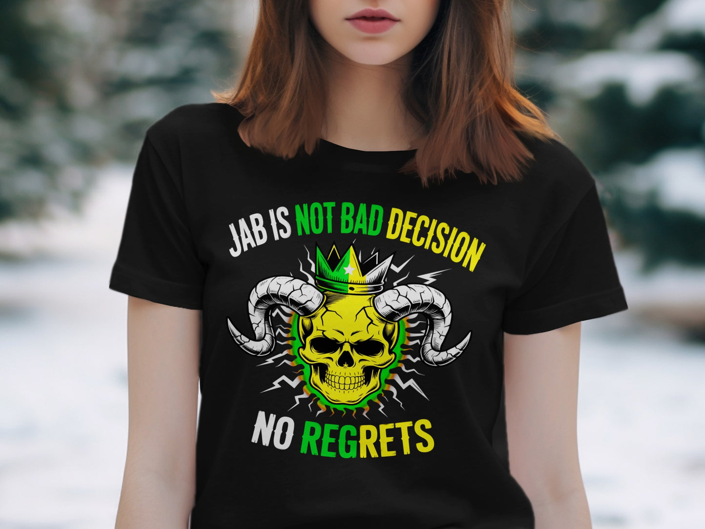 Black t-shirt with green and yellow skull, crown, and horns graphic, text reads "Jab Is Not Bad Decision No Regrets".