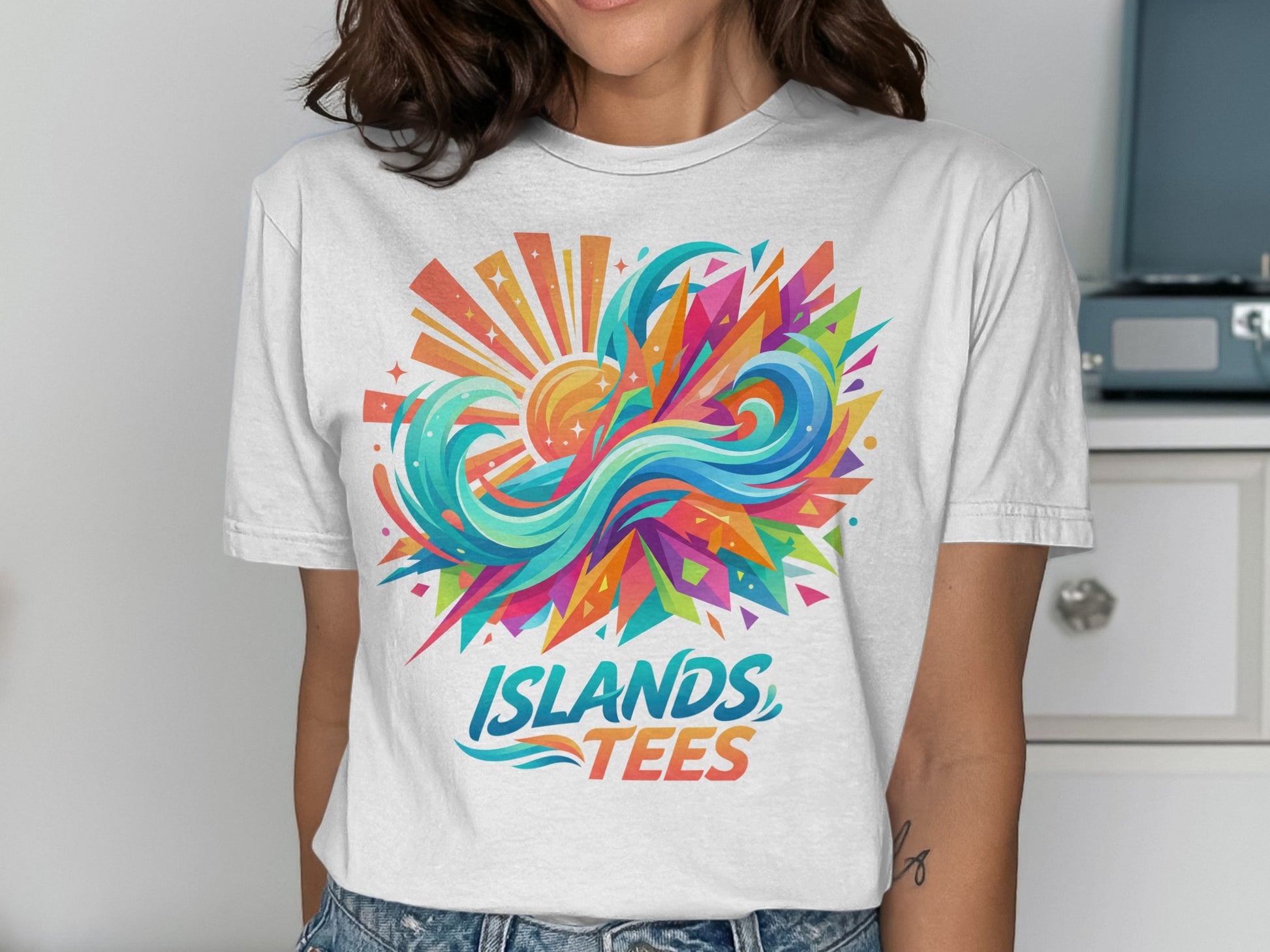 White t-shirt with abstract colorful sun and wave design, "ISLANDS TEES" text.