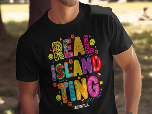 Black t-shirt with colorful "REAL ISLAND TING" text and tropical graphics.