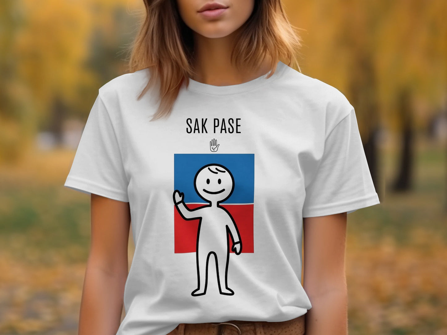 White t-shirt with "SAK PASE" text and a stick figure waving in front of a blue and red flag.