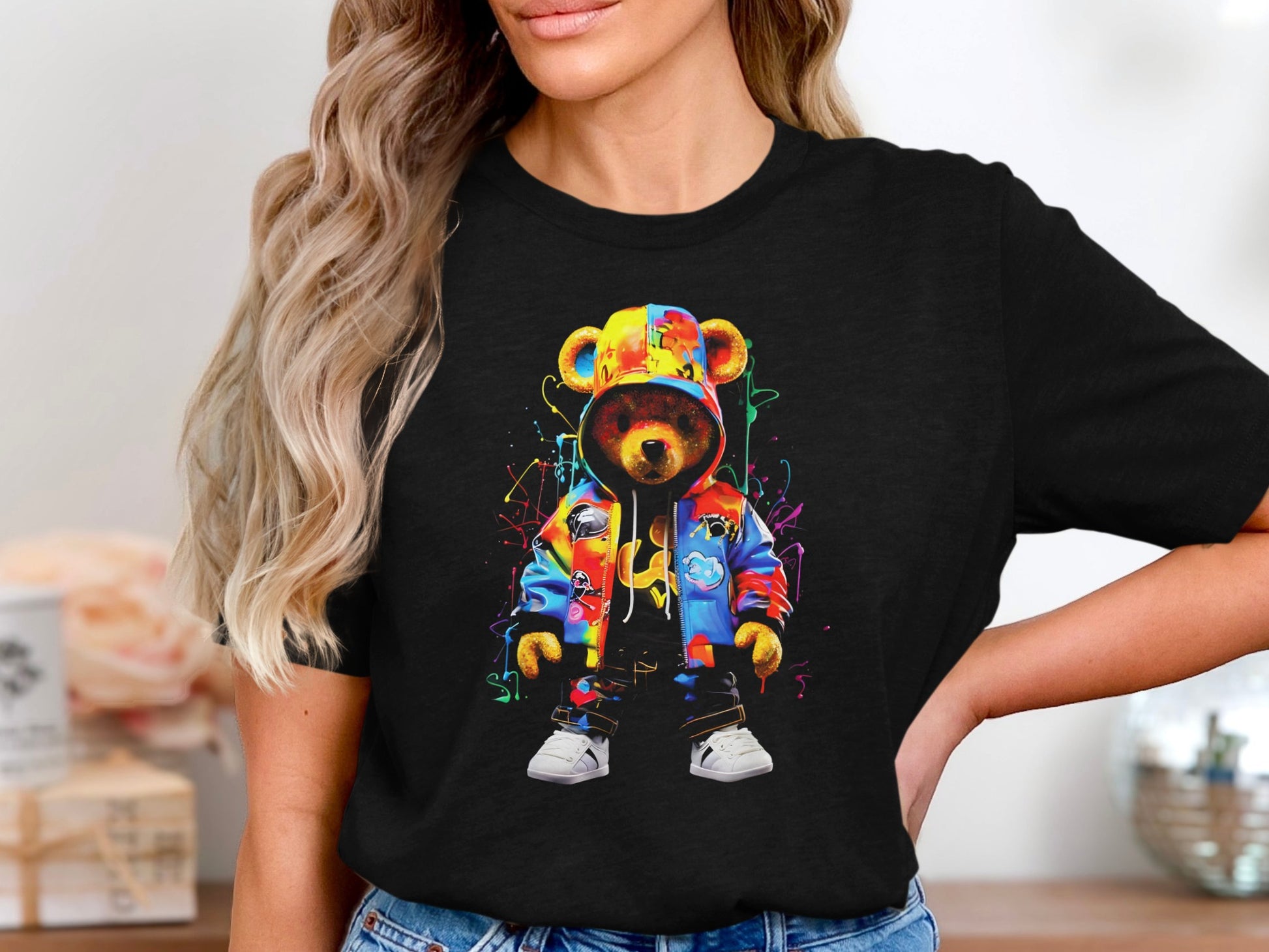 Colorful graffiti-style teddy bear wearing a hoodie and jacket on a black t-shirt.