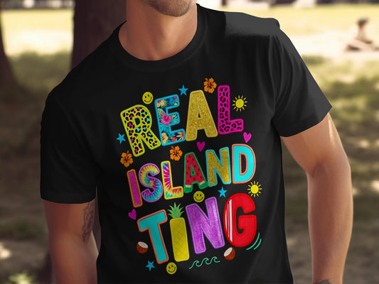 Black t-shirt with colorful "REAL ISLAND TING" text and tropical graphics.