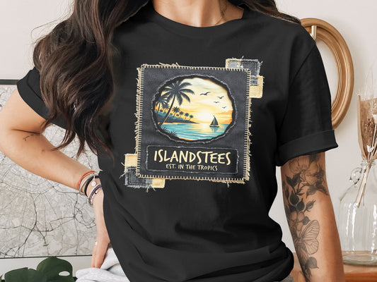 Black t-shirt featuring a tropical sunset scene with "Islandstees Est. in the Tropics" text.