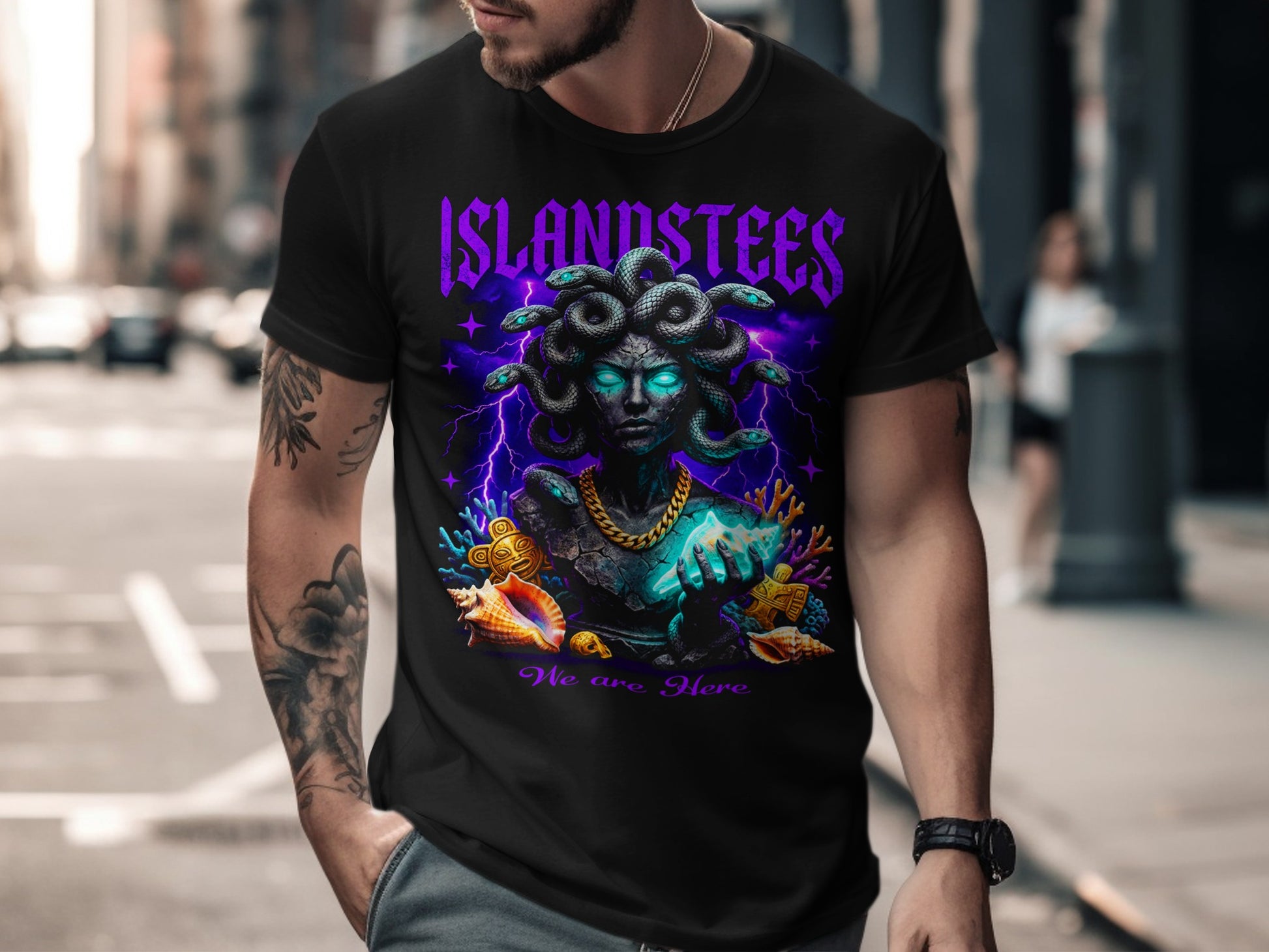 Black t-shirt with Medusa design, purple lightning, and "We are Here" text.