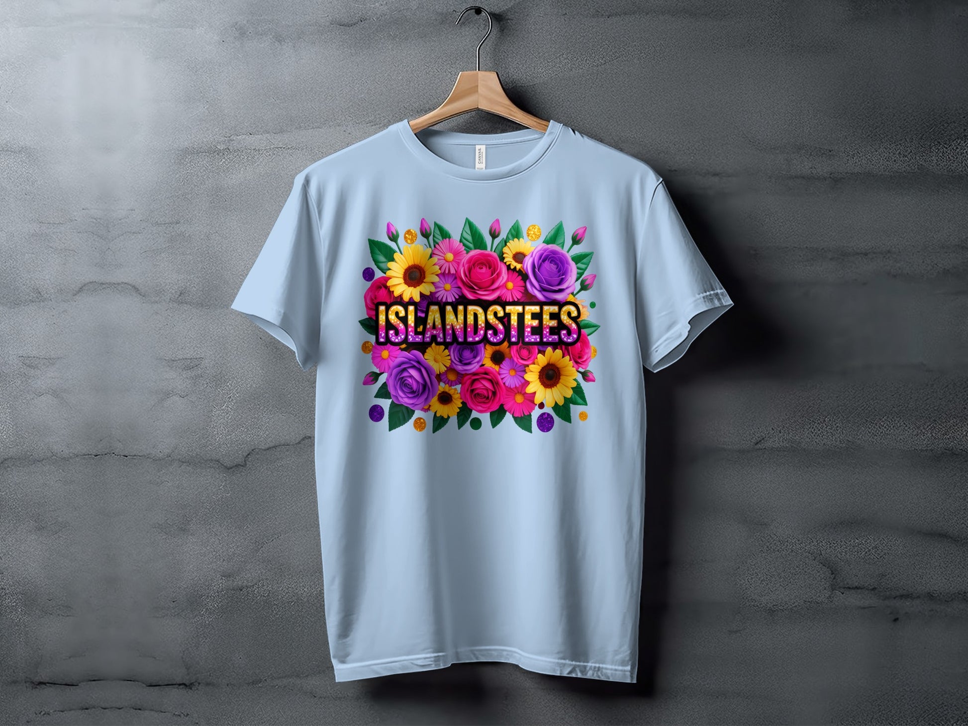 Light blue t-shirt with colorful floral design and "ISLANDSTEES" text.