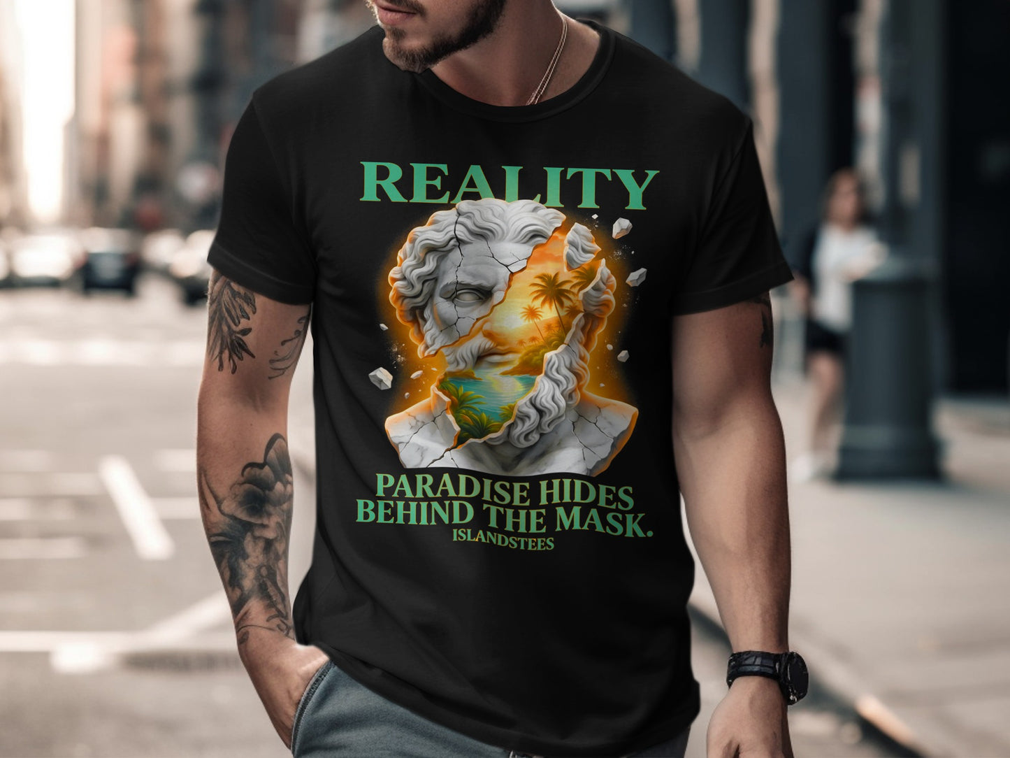 Black t-shirt with "REALITY PARADISE HIDES BEHIND THE MASK." text and cracked statue graphic.