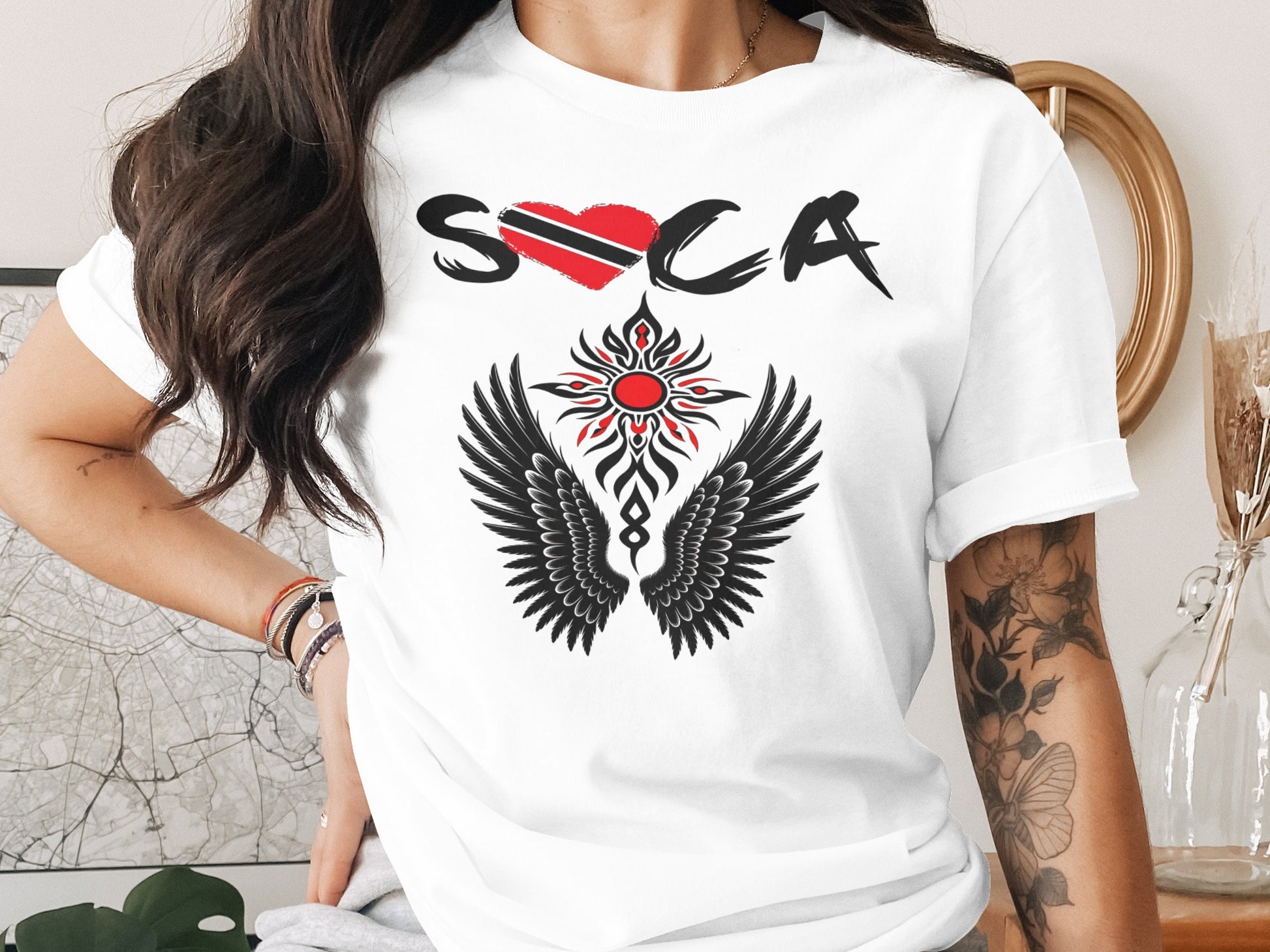 White t-shirt with red heart, black wings, and "Soca" text.