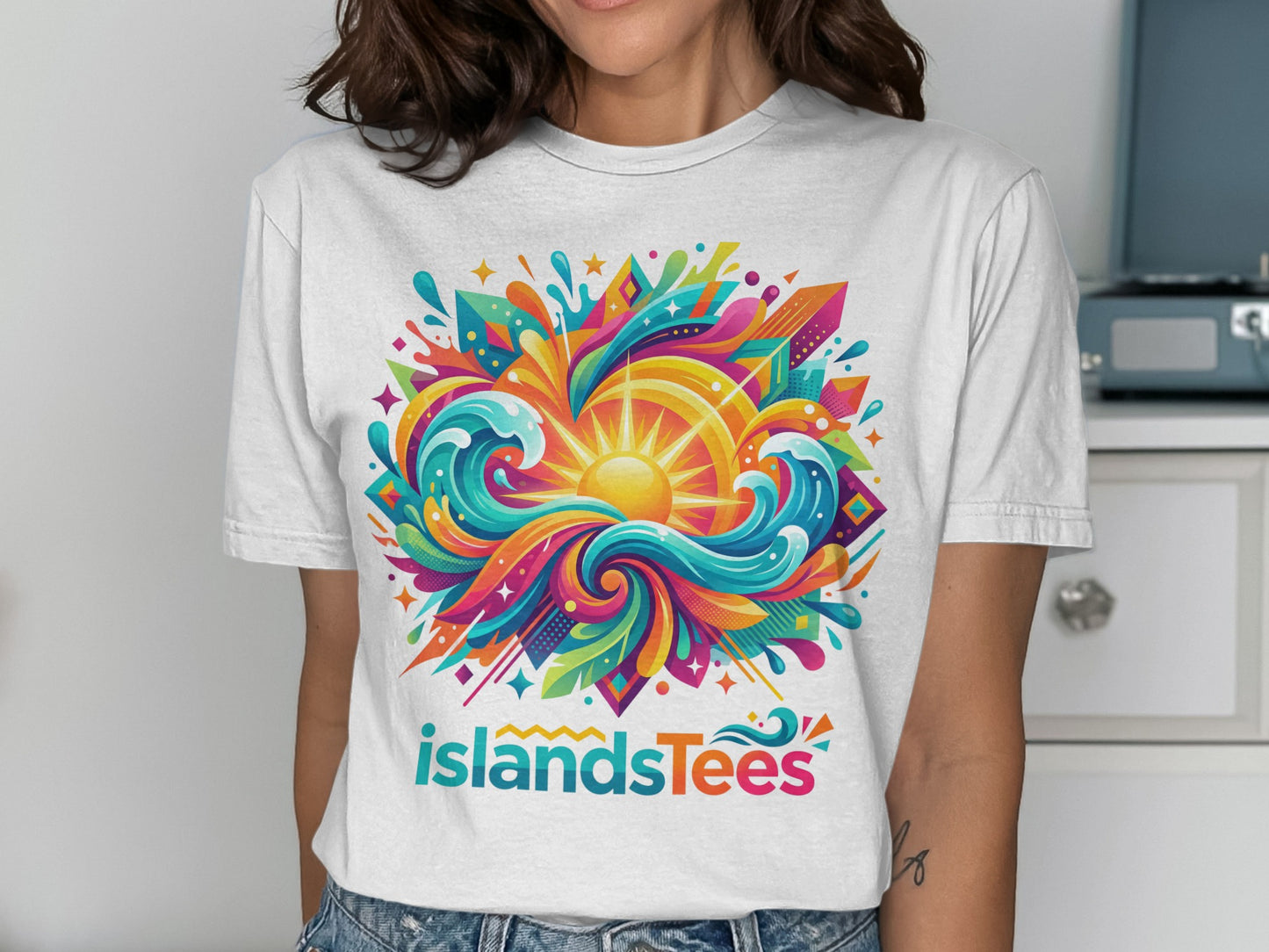 White t-shirt with colorful sun and ocean waves graphic, "islandsTees" logo.