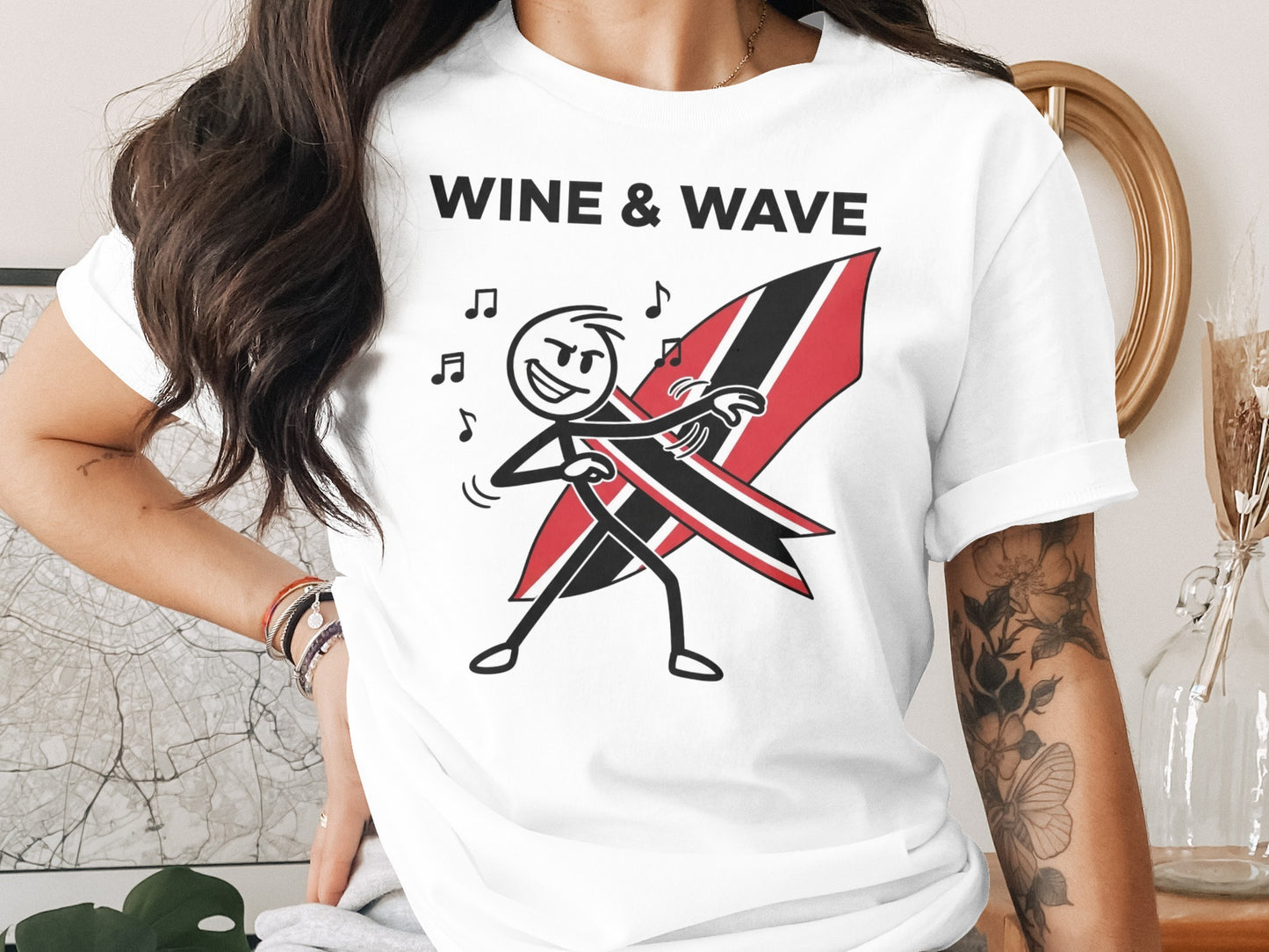 White t-shirt with "Wine & Wave" logo and stick figure surfing a Trinidad and Tobago flag.