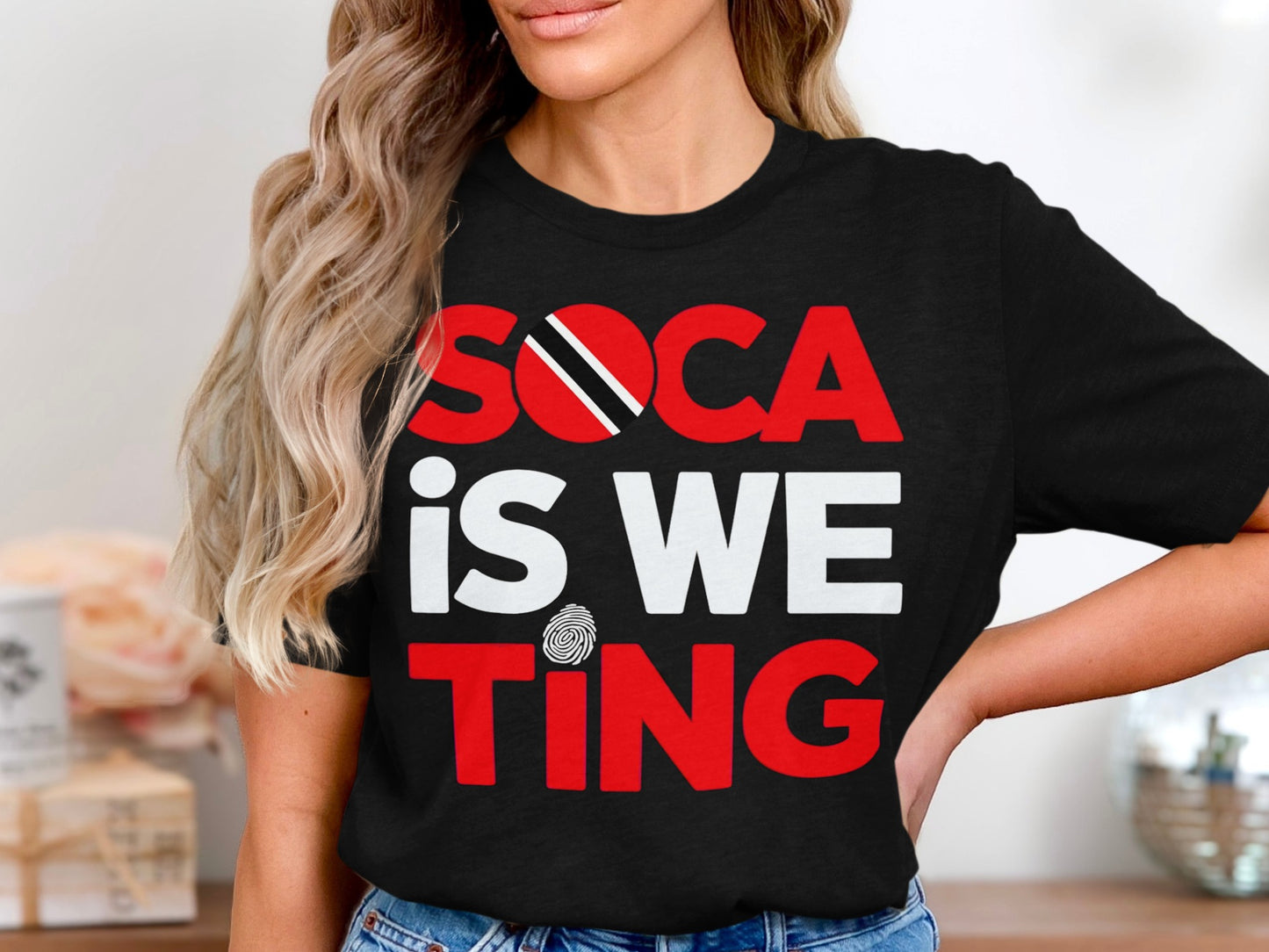 Black t-shirt with "SOCA IS WE TING" printed in red and white.