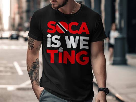 Black t-shirt with "SOCA IS WE TING" in red and white lettering, flag accents.