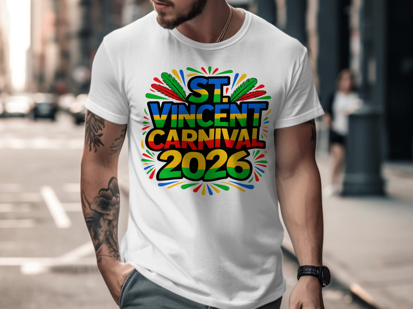 White t-shirt with "St. Vincent Carnival 2026" text and colorful feather accents.