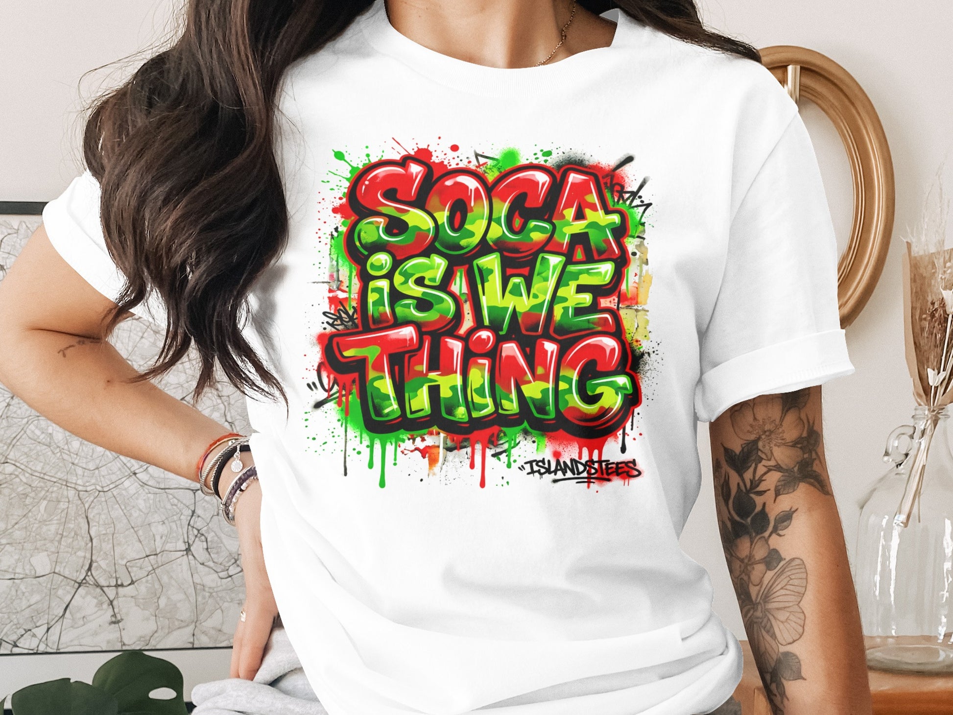 White t-shirt with vibrant "Soca Is We Thing" graffiti-style text.