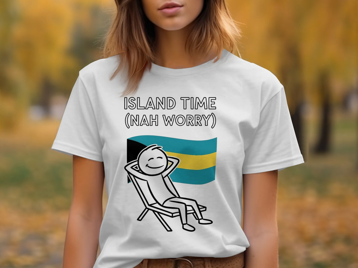 White t-shirt with cartoon figure relaxing in a chair, Bahamian flag, and "Island Time (Nah Worry)" text.