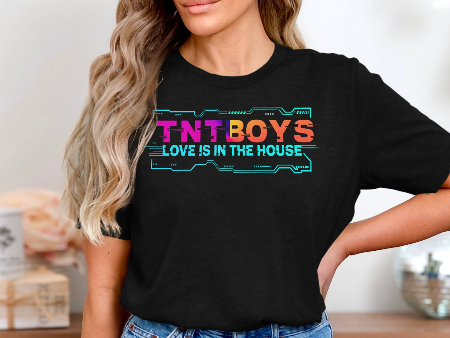 Black t-shirt with "TNT BOYS LOVE IS IN THE HOUSE" in colorful, glitchy text.
