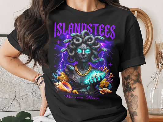 Black t-shirt with glowing Medusa graphic and "Islandstees We are Here" text.