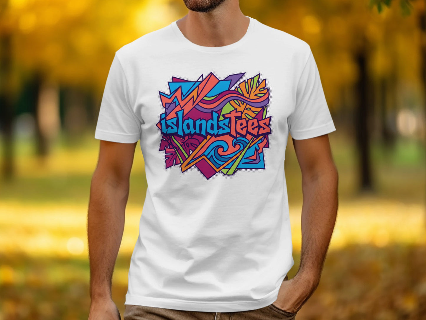 White t-shirt featuring abstract colorful "Islandstees" logo with autumn foliage background.