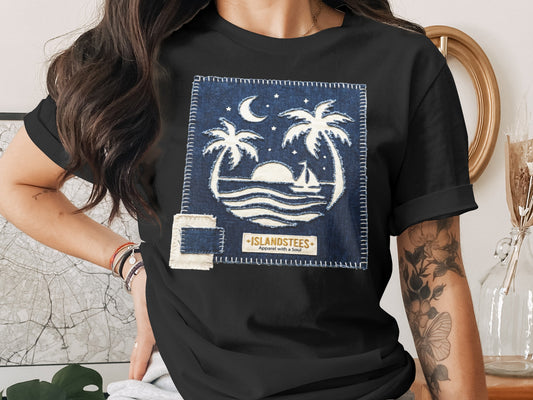 Black t-shirt with a denim patch featuring a tropical sunset and palm trees graphic.