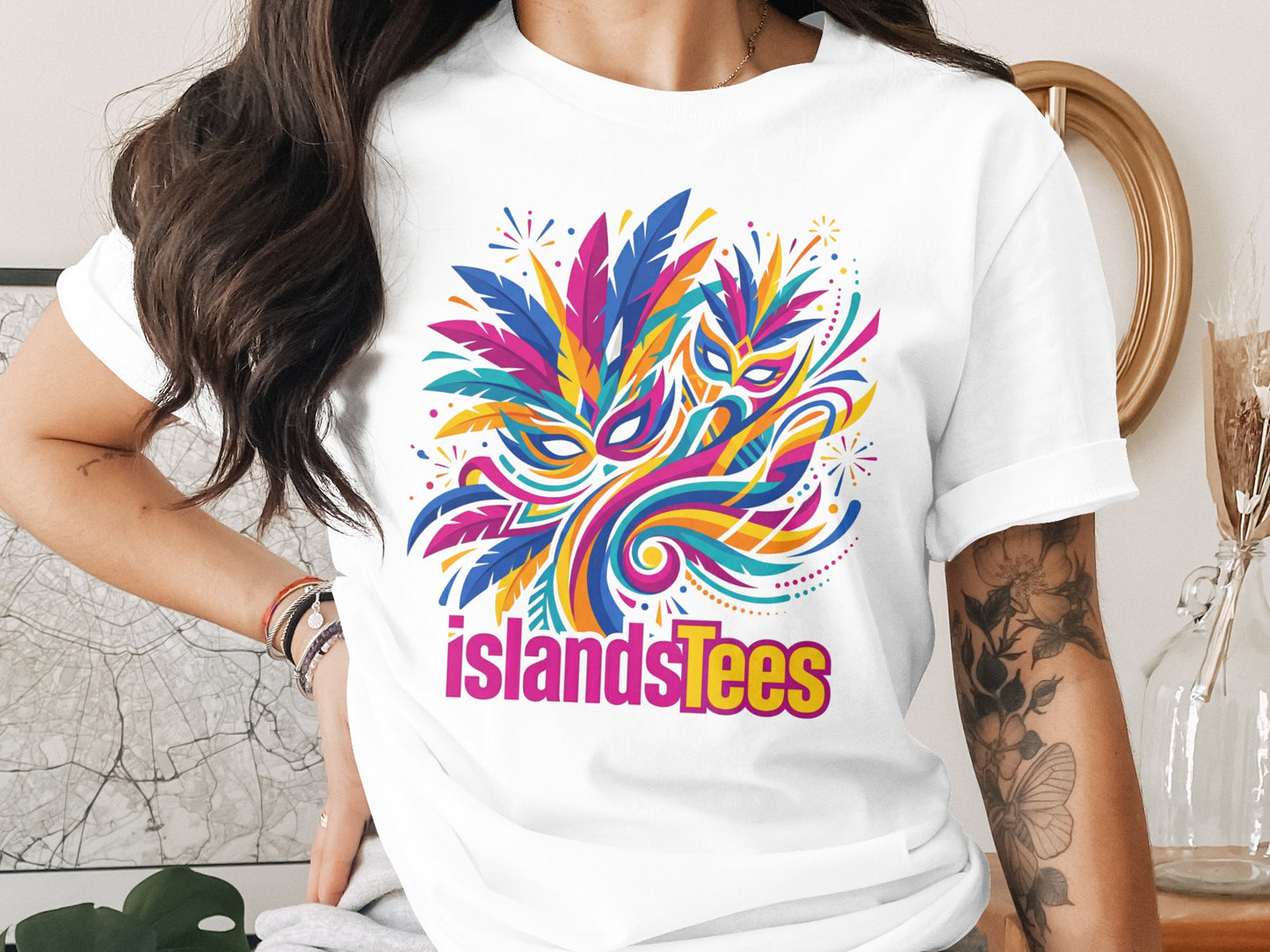 White t-shirt with colorful abstract mask and feathers graphic, "islandTees" text.