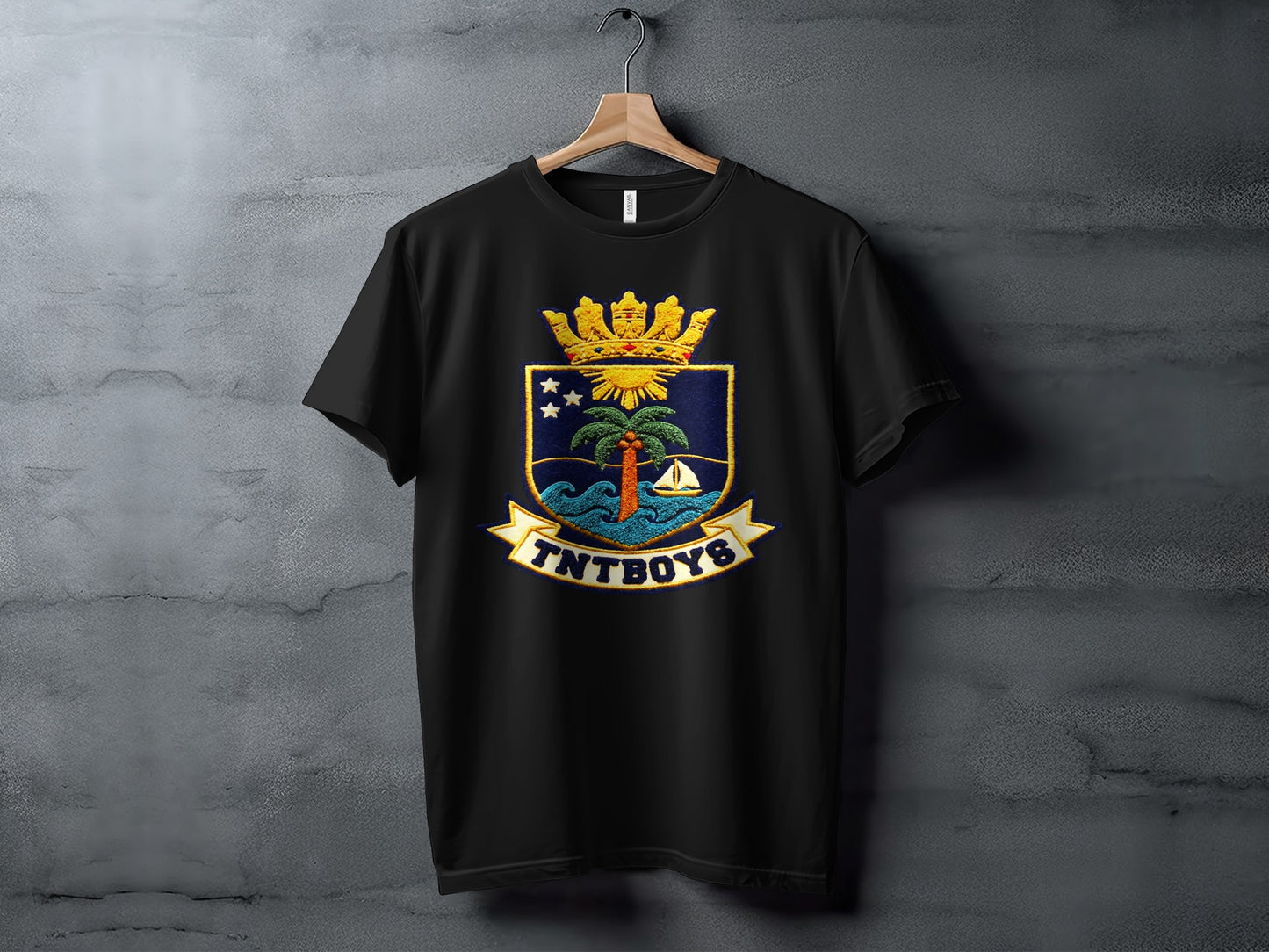 Black t-shirt with a crest featuring a palm tree, sailboat, and "TNTBOYS" text.