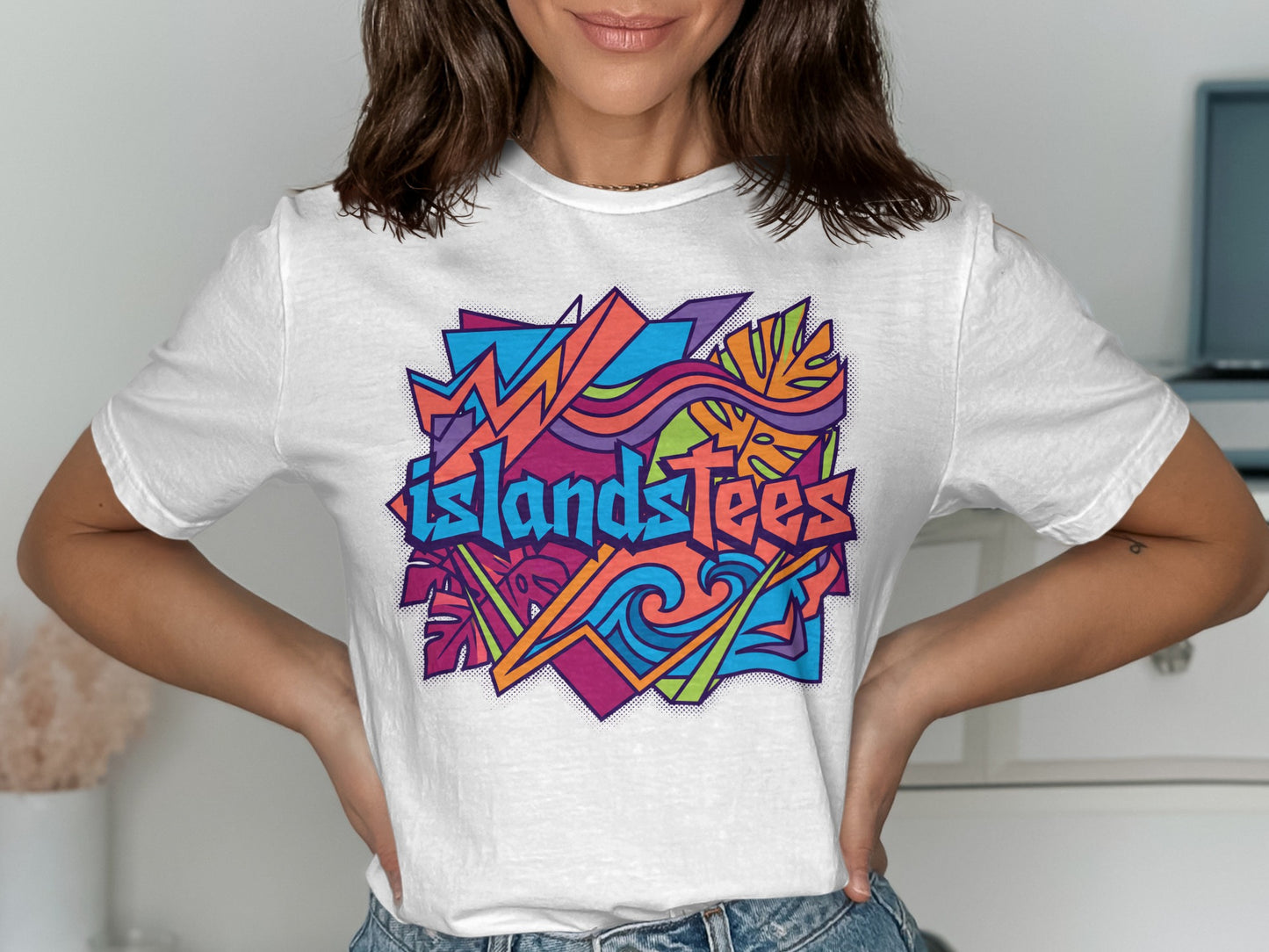 White t-shirt with colorful abstract "IslandTees" graphic design.