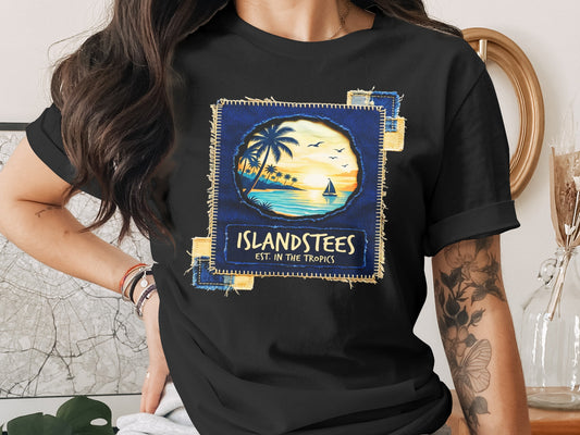 Black t-shirt featuring a tropical sunset scene with text "Islandstees est. in the tropics."