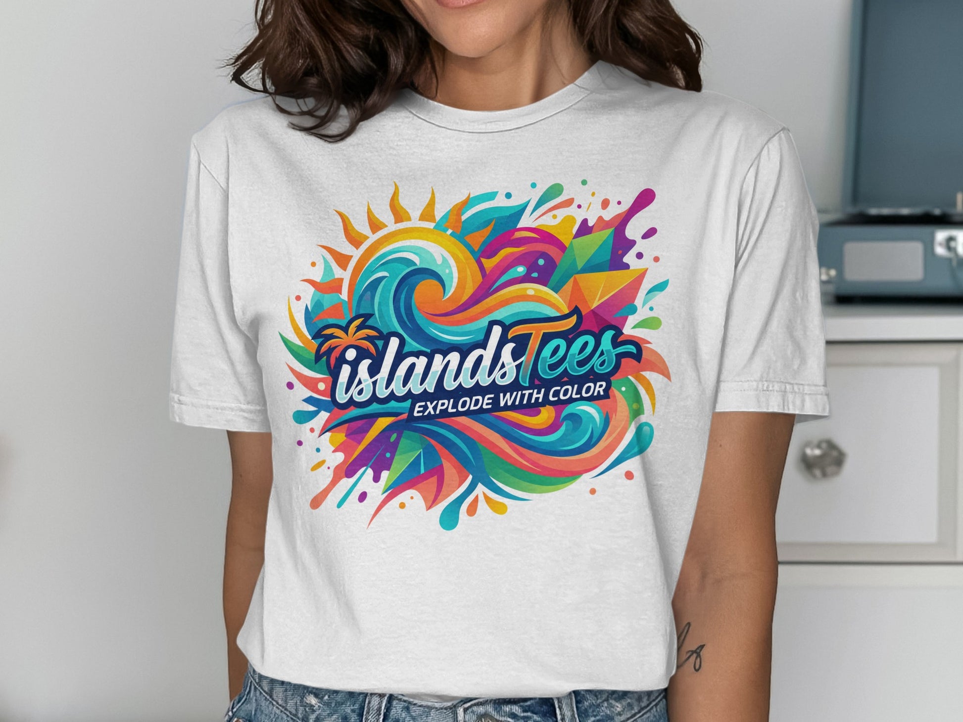 White t-shirt featuring "IslandsTees" logo with colorful waves and sun design.