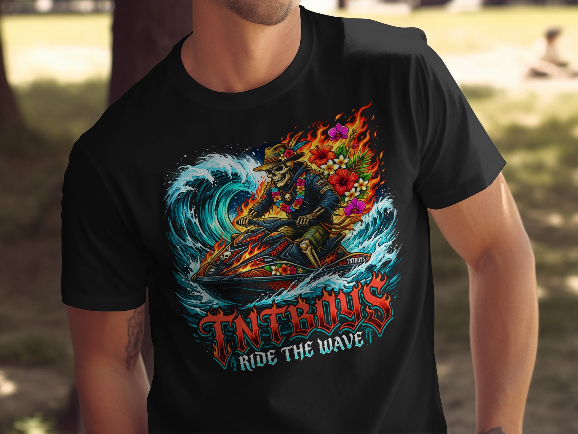 Black t-shirt with graphic of skeleton riding a jet ski through a wave with flowers.