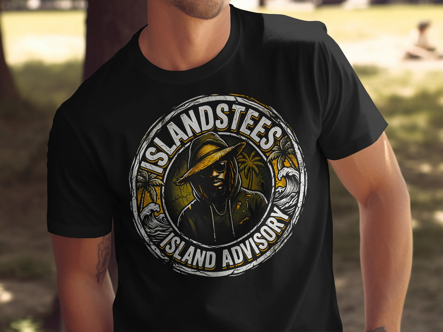 Black t-shirt with "Island Tees Island Advisory" logo featuring a man in a hat.