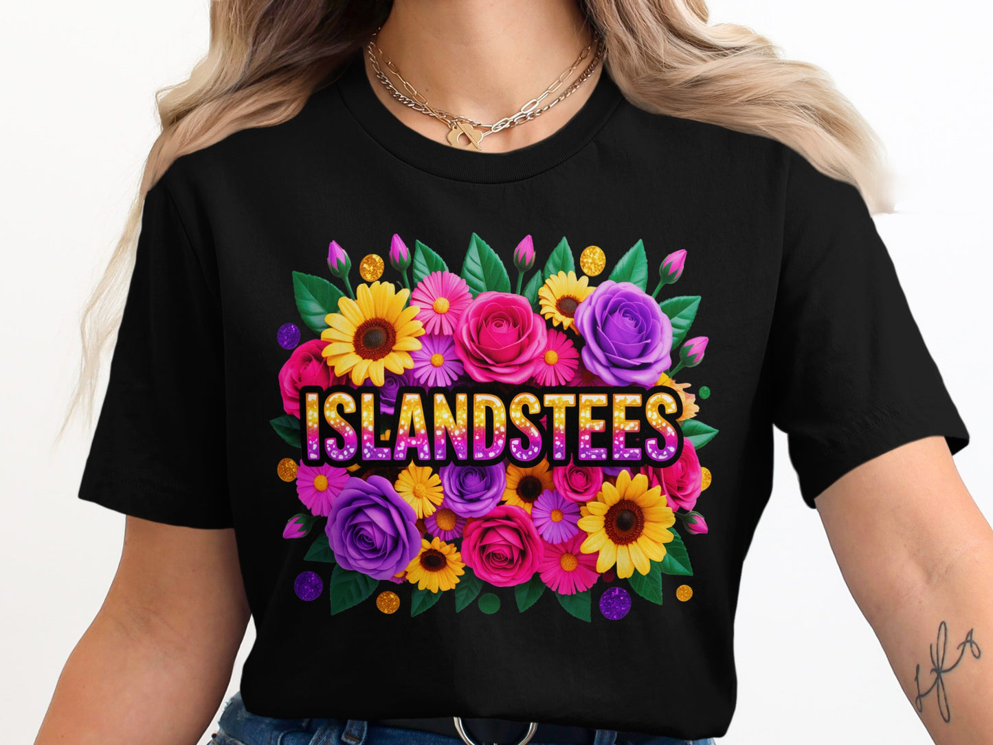 Black t-shirt with floral arrangement and "ISLANDSTEES" text.