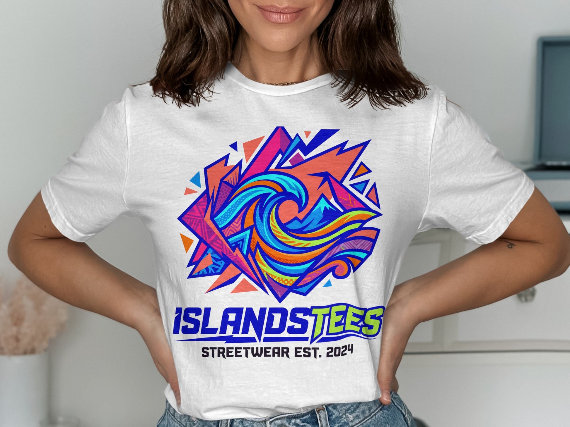 White t-shirt with colorful geometric wave graphic and "ISLANDSTEES STREETWEAR EST. 2024" text.